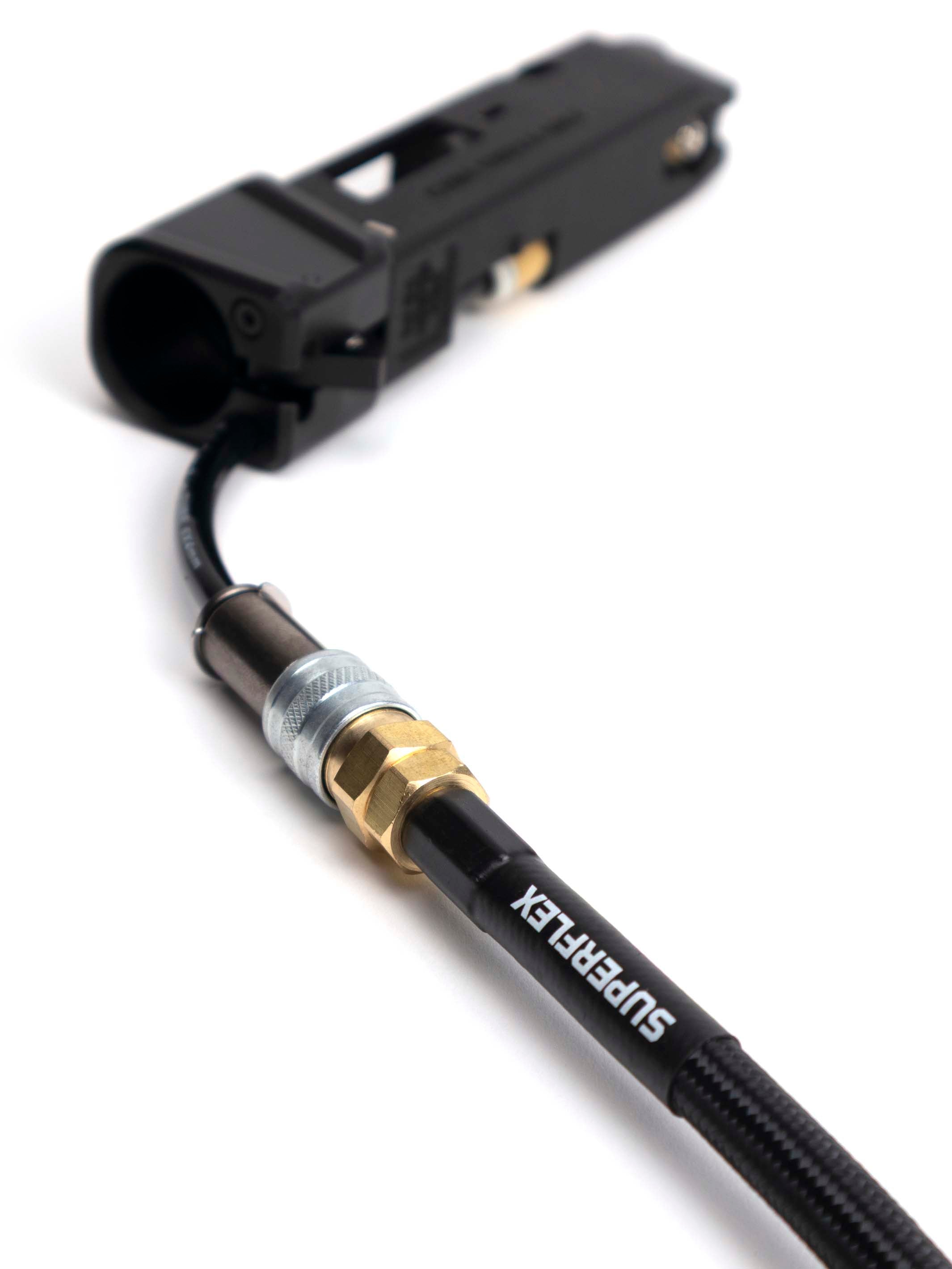hpa air line with black braided sleeve and US spec foster fittings attached to a AAP-01 shot shell adapter