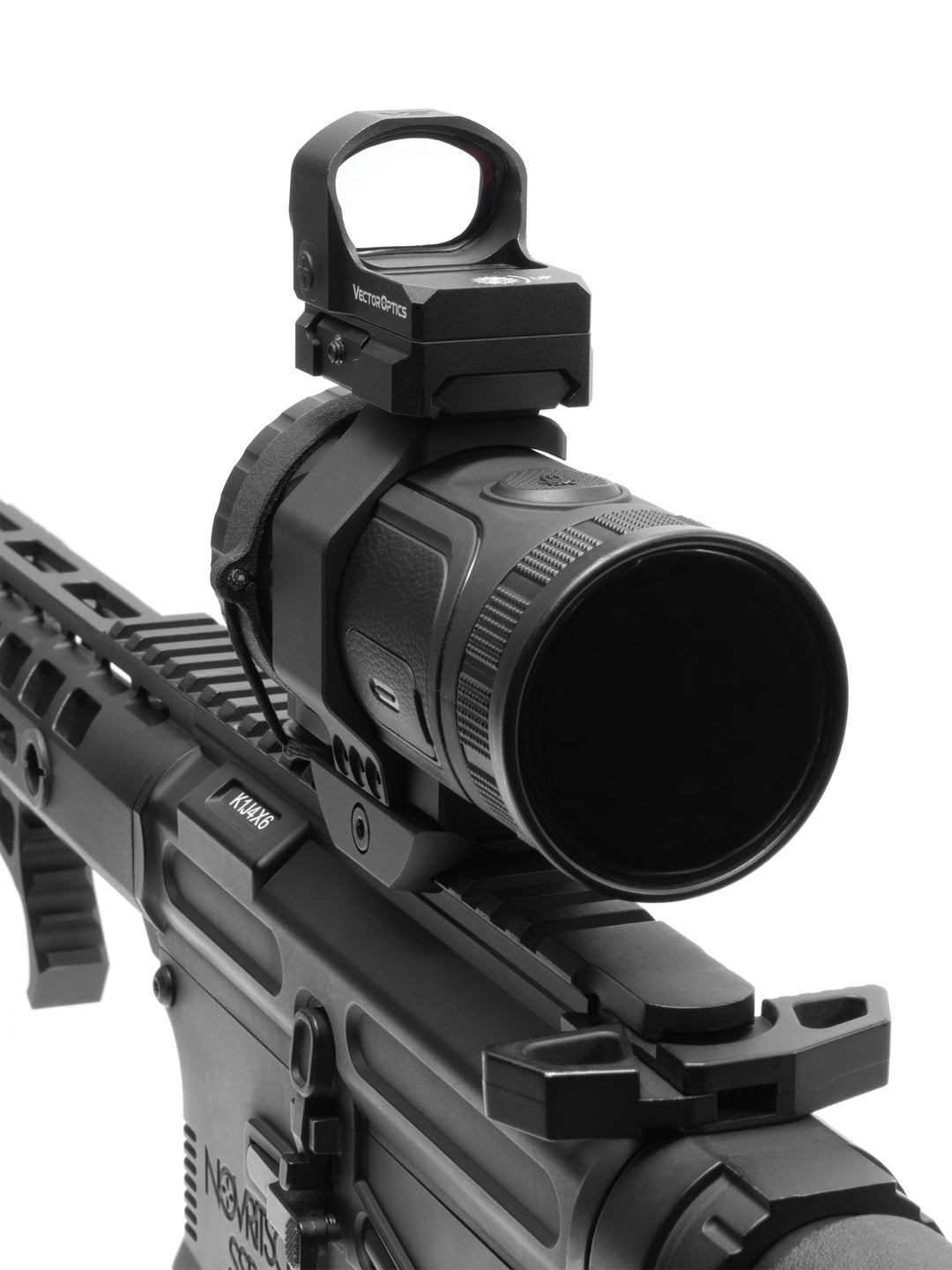 Close-up of a red dot sight on the top mount rail above the thermal monocular objective