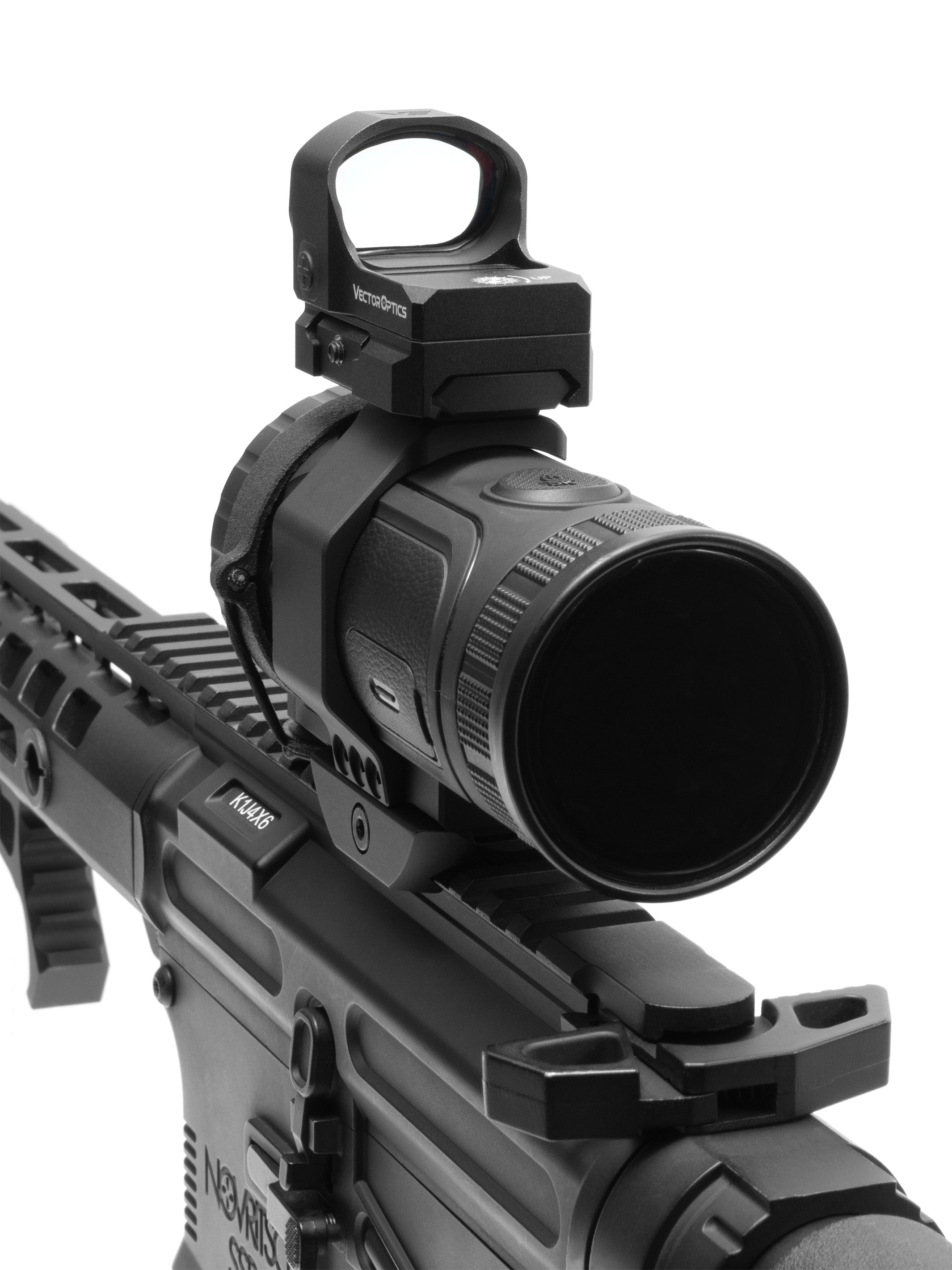 Close-up of a red dot sight on the top mount rail above the thermal monocular objective