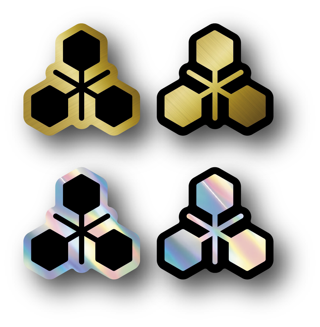 Four TRIDOS logo stickers in gold and holographic finishes, positive and negative cutouts