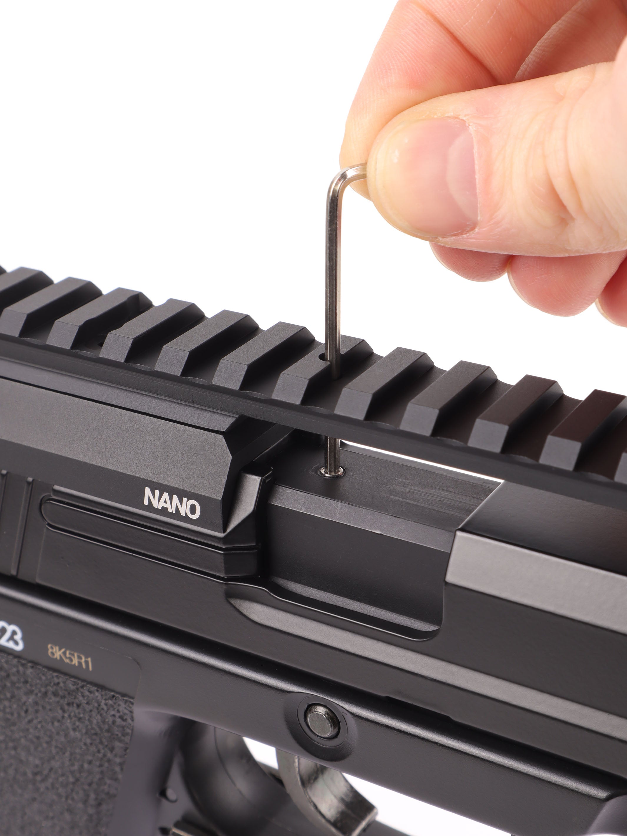 Hex key threading the front mounting screws through the rail into the SSX23 slide