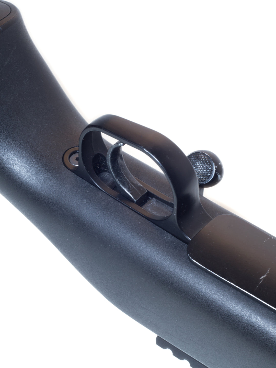 Angled view of the trigger dust cover fitted between trigger guard and trigger box on an SSG24